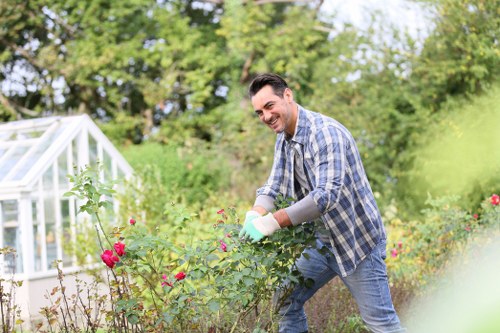 Team leader reviewing service records on a tablet at a garden site